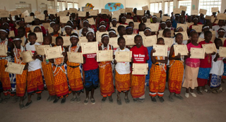 Masai girls in Magadi, Kenya, display completion certificates after an alternative rites of passage workshop (Anja Legtenberg)